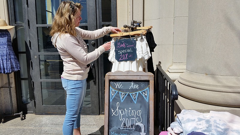 Shopper Julie Agnew checks out some discounted clothing at the Island Gypsy boutique on Asbury Avenue.