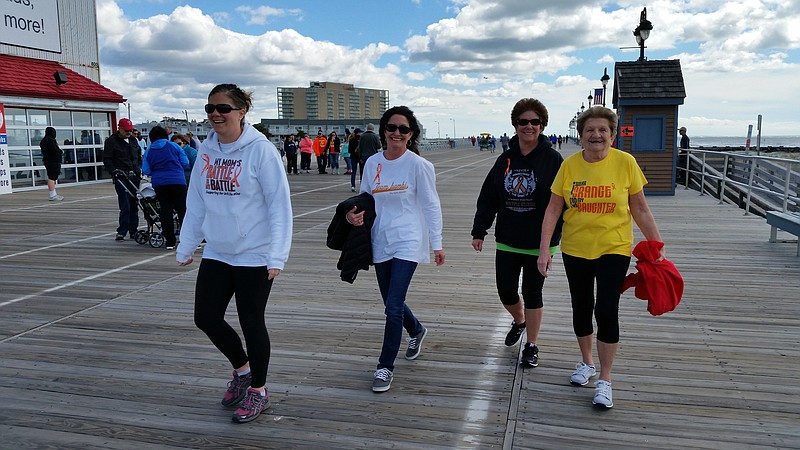 Linda Boyle, in black sweatshirt, and some of her supporters begin their walk on the Boardwalk.