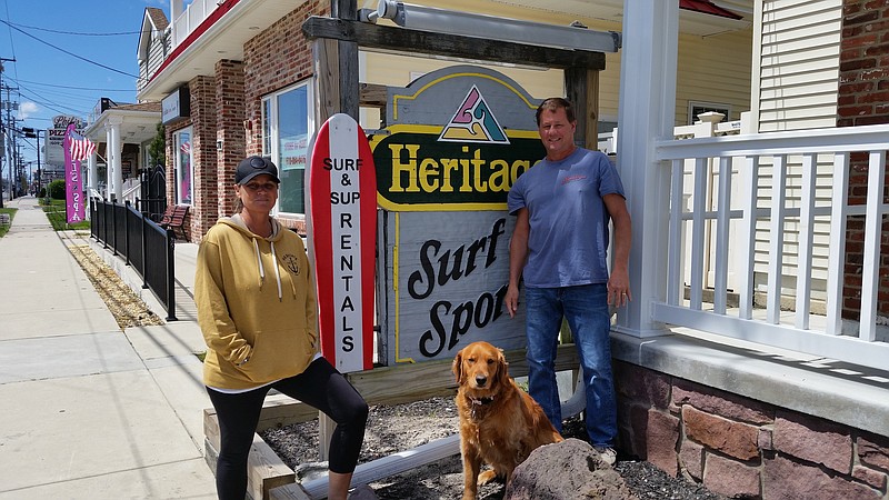 Heritage and his wife, Jamie, are joined by their golden retriever, Jessie, in front of their Sea Isle shop on Landis Avenue.