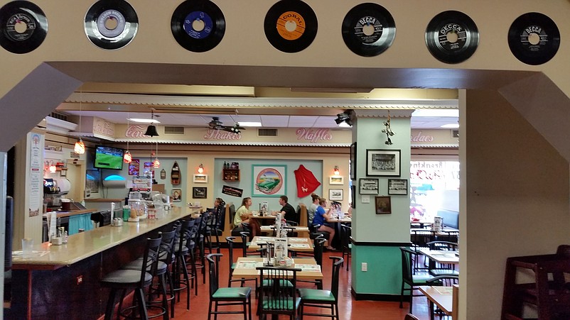 Old 45 rpm records attached to the walls add to the nostalgic atmosphere.