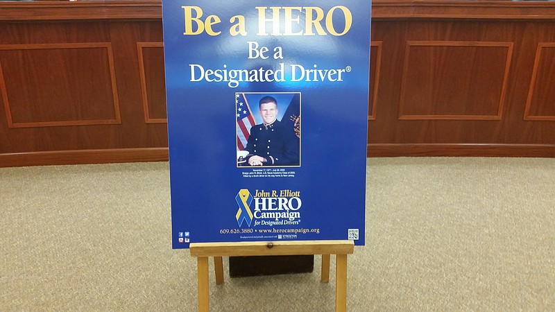 A photo of John R. Elliott dressed in his Naval uniform serves as the iconic image of the HERO Campaign.