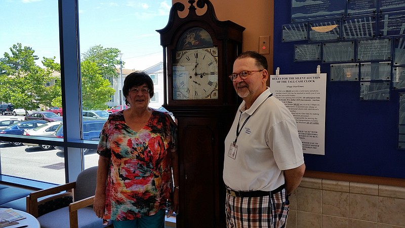 Babs Stefano and Stephen Gring, trustees of the Ocean City Historical Museum, stand by an 1820 Scottish grandfather clock that sold for $1,000.