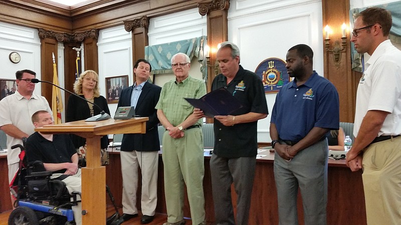 Gene Farrell, center, in green shirt, joins members of City Council as they honor his late wife, Maryellen Farrell, for her contributions to the community.