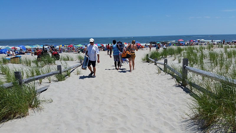 Beachgoers take advantage of sunny skies and temperatures in the low 90s.