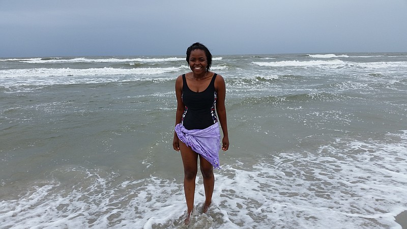 Angelique Ines, of Toledo, Ohio, braved the rain and choppy surf to take a dip in the 74-degree ocean.