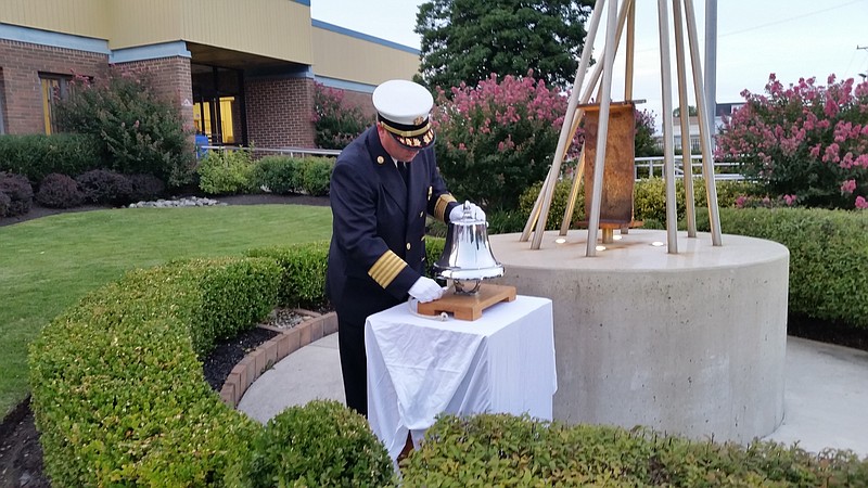 Ocean City Fire Chief Jim Smith rings a silver bell to honor the victims of the 9/11 attacks.