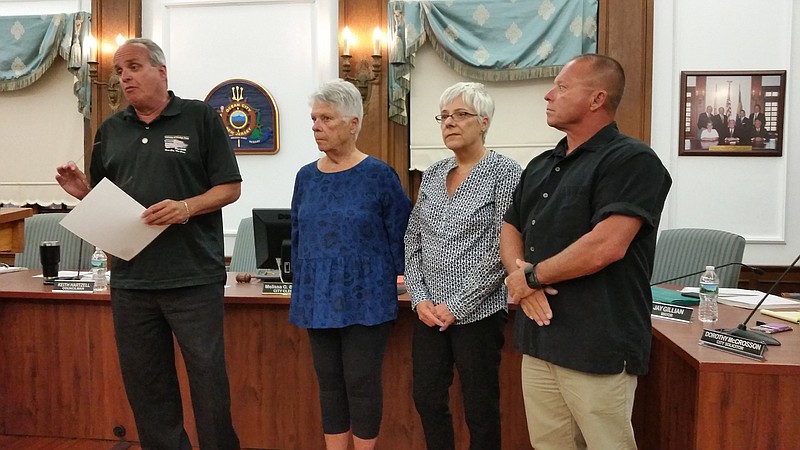 Councilman Keith Hartzell, left, reads a resolution honoring the late Richard P. Galante while accompanied by Galante's wife, Edie, daughter, Lori Smith, and son, Tony Galante.