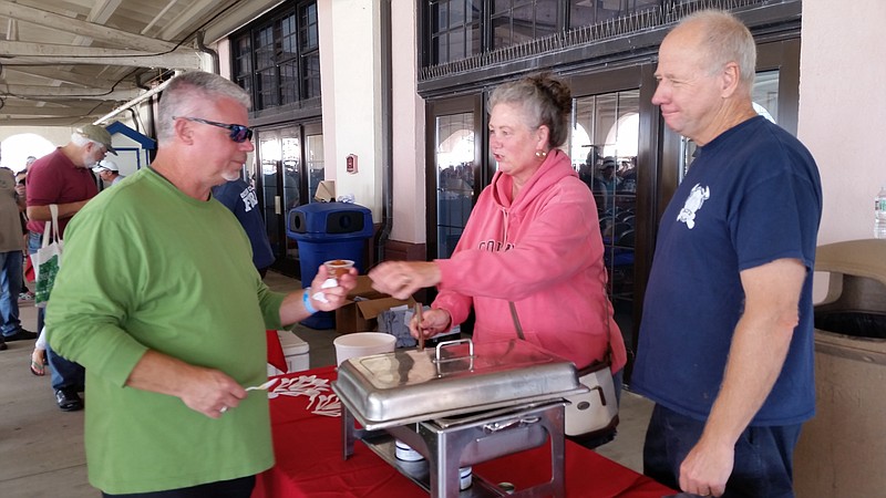 Ocean City firefighter Chris Meyer, right, receives some help from his wife, Ruthann, while serving chili to a festival-goer.