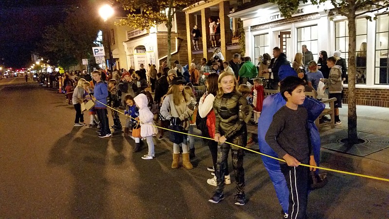 Children lined Asbury Avenue waiting for parade marchers to throw them some candy.