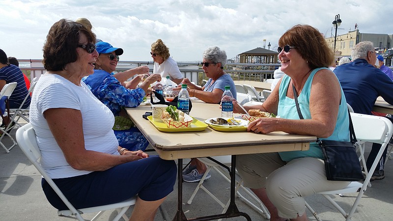 Eleanor Dalotto, left, of Jackson Township, N.J., and Lois Wright, of Old Bridge, N.J., enjoy their seafood meals and an oceanfront view at the Music Pier.