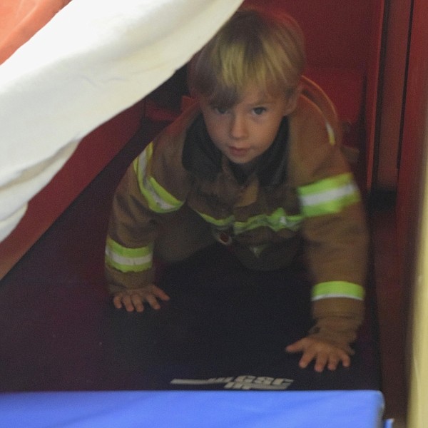 Ben Dougherty, age 4, finishing up the game 'Get Out. Stay Out. Crawl Low.' and doing his best fireman impression.