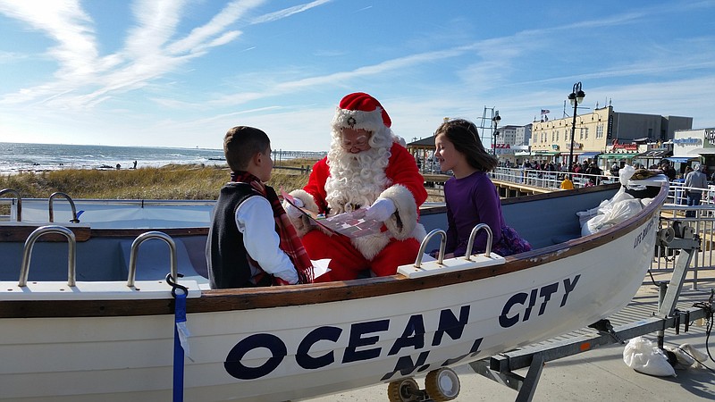 Santa reads a wish list and holiday cards given to him by 5-year-old Connell Hennessey and his 7-year-old sister, Olivia last November.