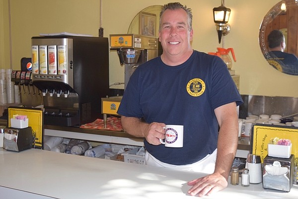 A busy Doug Wing is enjoying some coffee on a quick break