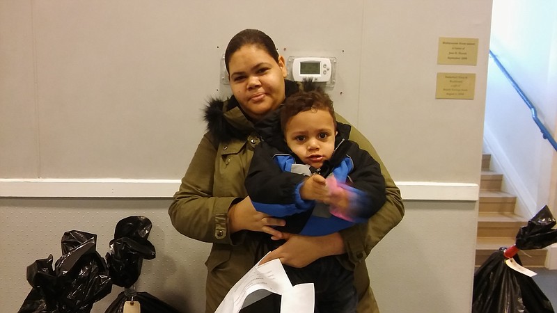 Maria Guzman and her son Juan stopped in at the Waves of Caring Toy Drive to receive their gifts.