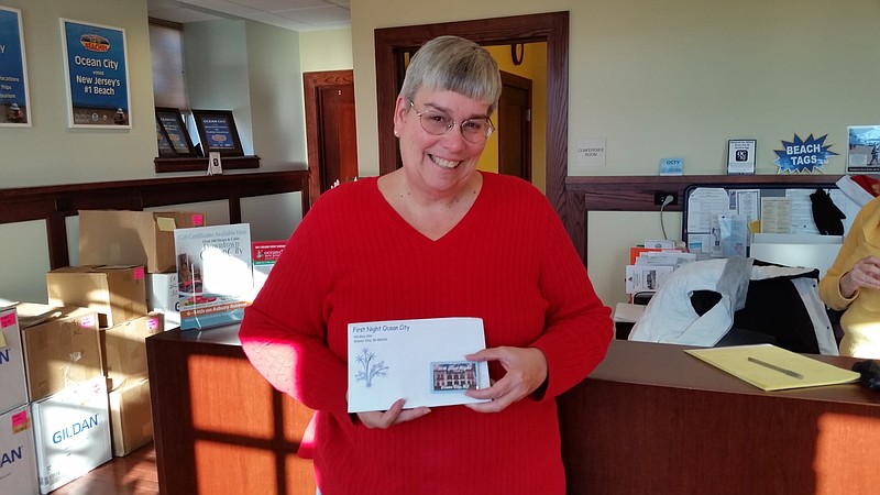 Robin Lord, principal accounting clerk, holds one of the First Night admission buttons for Ocean City's holiday festivities. 