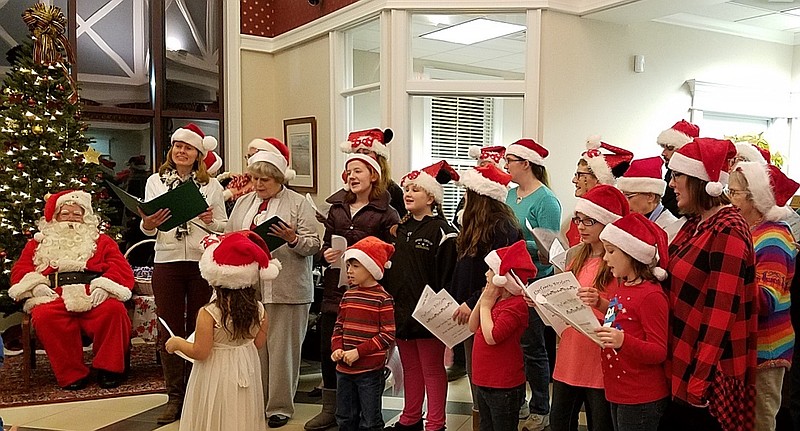 The UpTown Singers Choir joins Santa Claus in celebrating the holiday season during the annual Tree Lighting Event at the Sturdy Savings Bank Ocean City 34th Street Branch on December 6