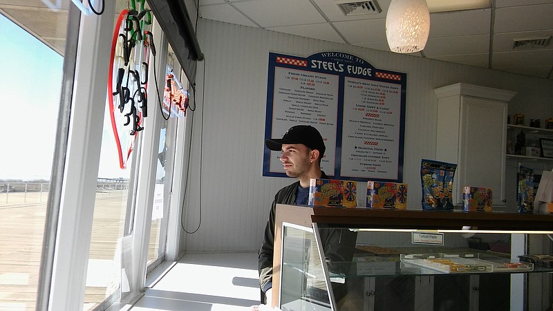 Ianos Gadzsa, an employee at Steel’s Fudge, 10th Street and the Boardwalk, surveys the new boards.