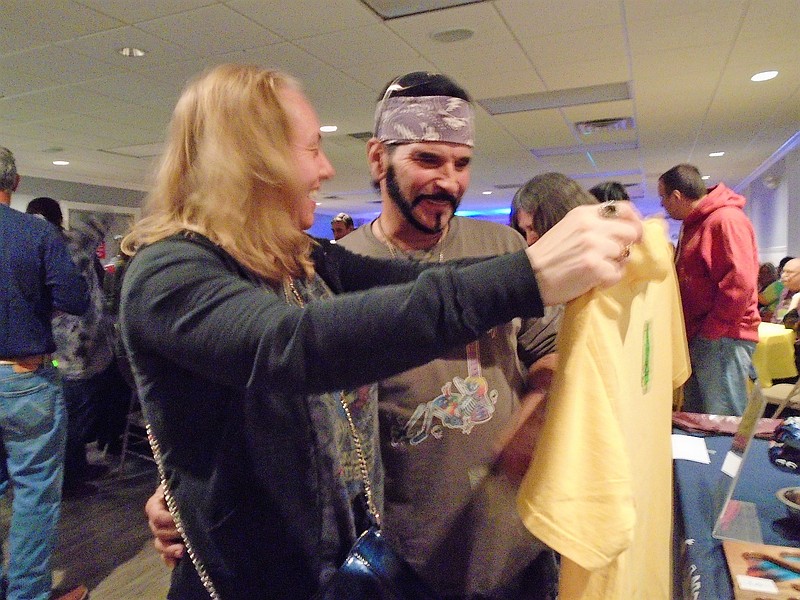 Couple Susan Stanisz and Frank Tomasulo check out some T-shirts. The animal lovers who have cats and a bird say they really believe in the cause.