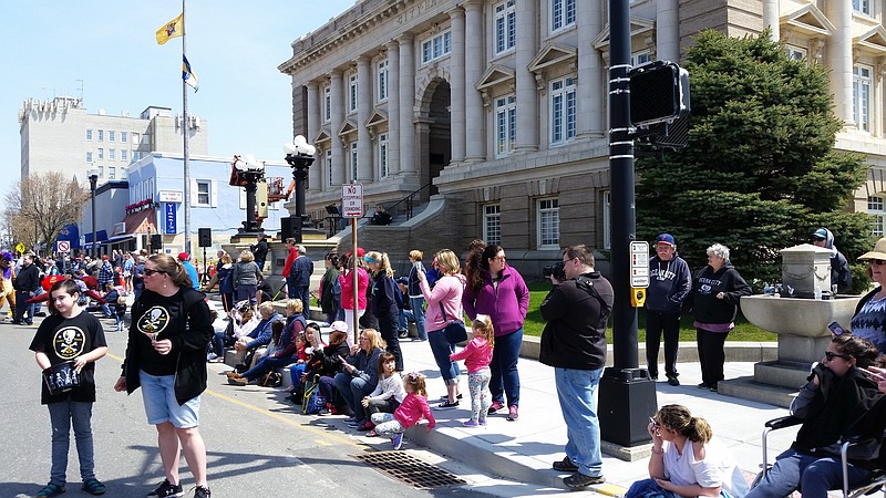 People line the parade route on Asbury Avenue near City Hall.