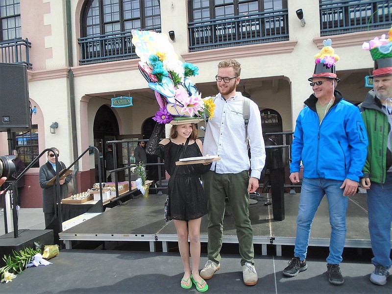 Victoria Bowman wins Most Unusual Bonnet for a second year in a row. Her brother Anthony supports the flip flop beach-inspired hat on his sister's head.