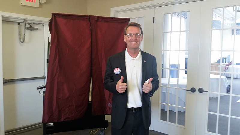 Mayor Jay Gillian flashes a thumbs-up sign after casting his vote at the Ocean City Yacht Club.