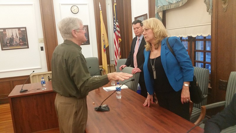 Tweed discusses his concerns with Council members Karen Bergman and Michael DeVlieger.