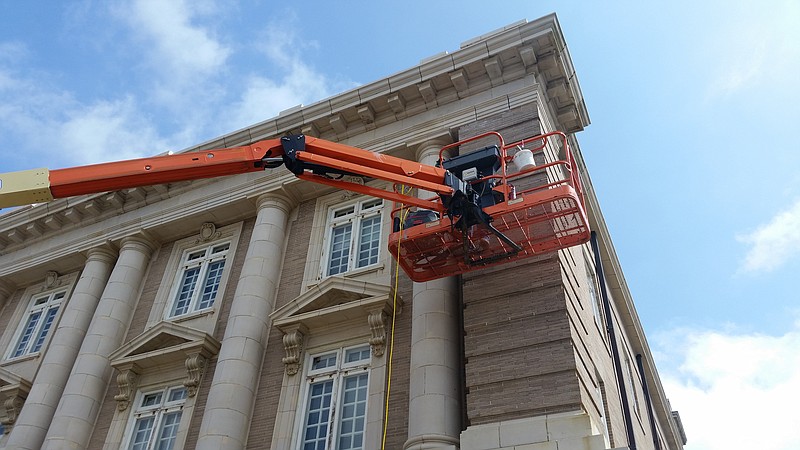 In 2018, a lift allows a worker to get right next to the building to do the intricate restoration work.