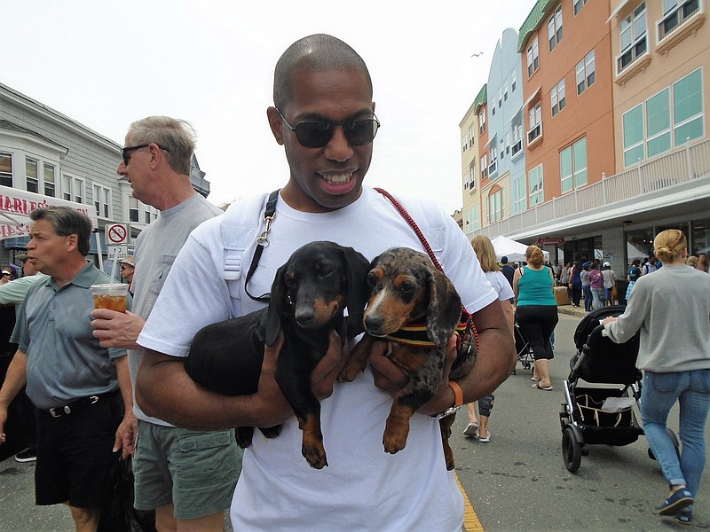 Mark Moses, of Ocean City and Texas, takes his puppies Shiner and Daphne to the block party.