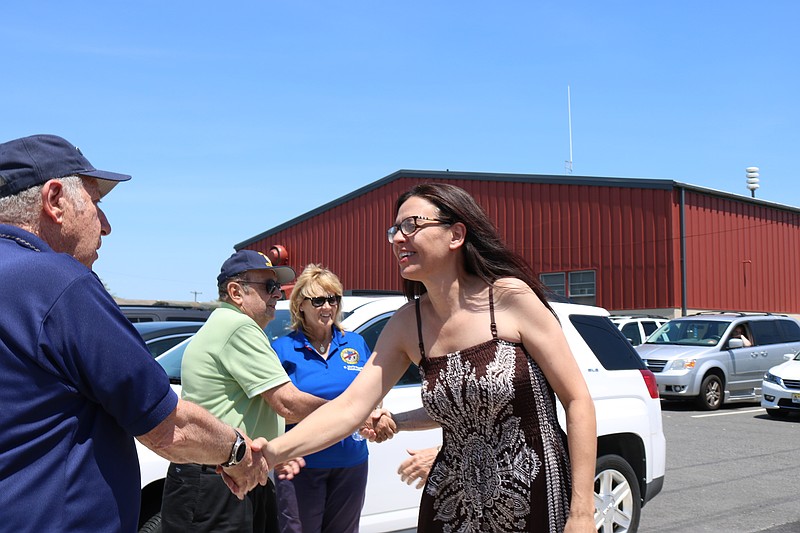 American Legion Post 524 member Steve Cole with Capt. Joanne Schultze as she makes her way into the legion for a celebration in her honor in 2018 for the R &amp; R Program. This year due to the outbreak, post officials will also provide funds to the local business owners who have donated each year to the program.