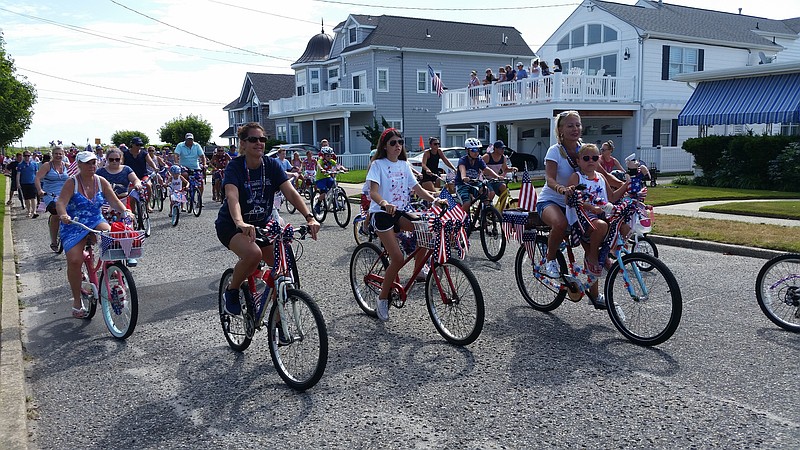 The holiday bike parade gets underway on Wesley Road in the Gardens section of town.