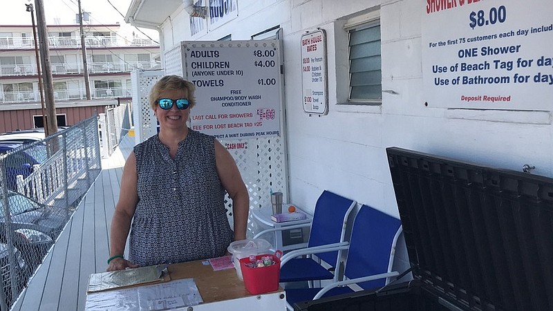 Employee Sharon Norton, whose fulltime job is teaching at Ocean City High School,  stands ready to help customers at the Bath House at 13th Street and the Boardwalk.