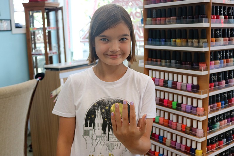 Noemie Lindstrom, 11, of London on vacation in Ocean City, proudly displays her newly painted nails.