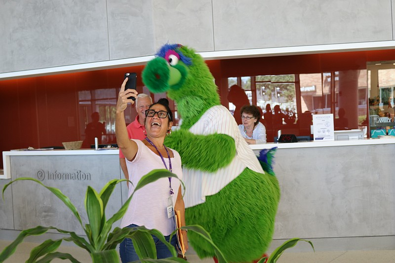 The Phillie Phanatic and fan do a selfie.