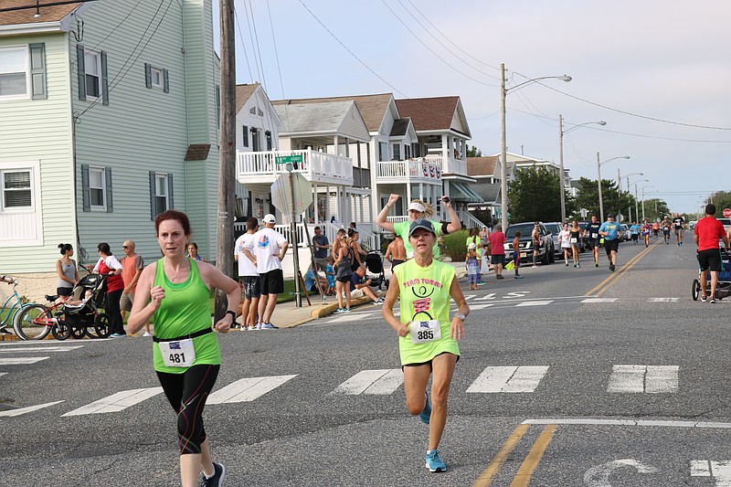 Runners are triumphant as they cross the finish line.