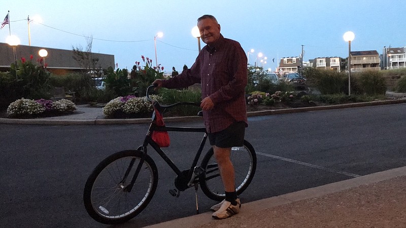 Doug Eberly, with his "rust proof" two-wheeler, gets ready for one of his daily pre-dawn rides.