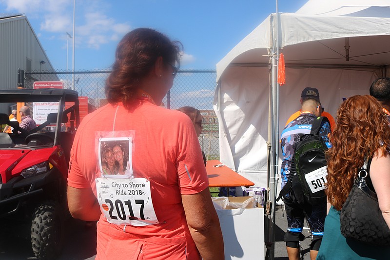 Renee Wacker, of Sicklerville, displays a picture of her and her sister, Elaine Kelly, who was diagnosed with MS 25 years ago.