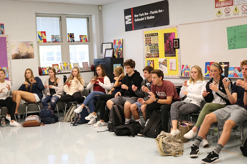 The students in the ASL program are engaged in signing during ASL teacher, Amy Andersen's lesson.