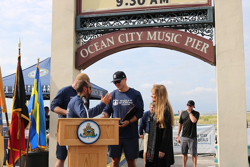 Army Specialist Cole Gaseperini, of Somers Point, with Nick Constantino and Peggy Baker of Operation First Response and emcee Steve Brady (Far left) OceanFirst Bank and Marine Sergeant Wyatt Clevenger (back) as Gasperini is given a warm welcome home.