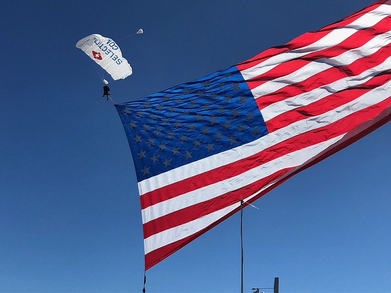 A gigantic American flag carried by the Fastrax professional skydiving team serves as a patriotic highlight for the air show in 2018.