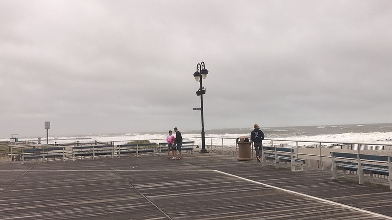 Boardwalk strollers marveled over the ocean whitecaps kicked up by the stormy conditions.