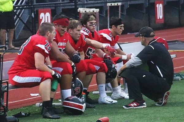 Red Raiders Head Coach Kevin Smith talks to his players during the win against Bridgeton. 