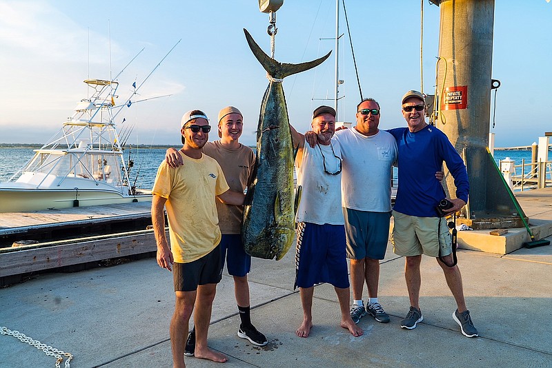 Eddie Kelly, 15, of Ocean City, second from left, stands with his huge catch, a 66-pound mahi-mahi. (Courtesy Ron Gallagher)