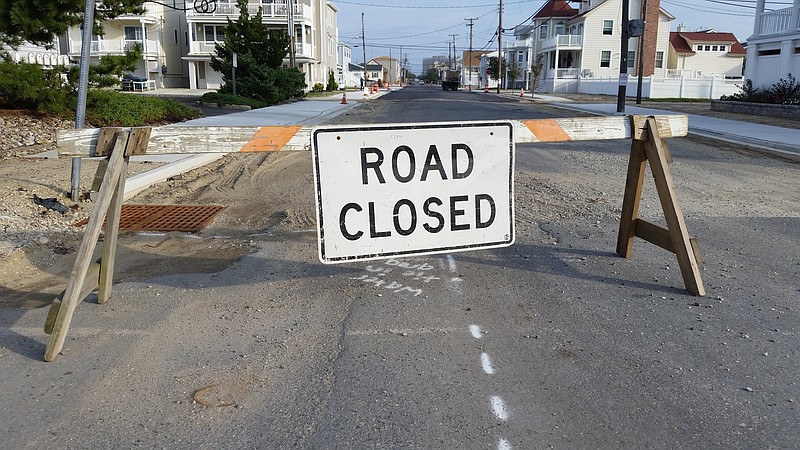 A "Road Closed" sign blocks the way at Bay Avenue and Third Street during construction on the drainage project.