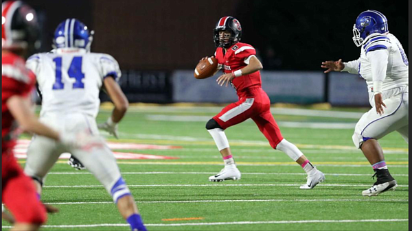 Red Raiders QB Ian Aungst sprints out and looks to pass against Oakcrest last week.