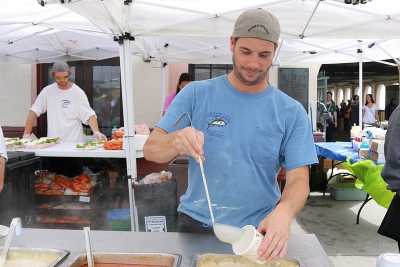 Ed Aleszczyk, of Spadafora’s Seafood Restaurant, says customers love the chowders. He spent the day scooping the homemade soups into cups at the seafood festival on the Music Pier in Ocean City Sunday.