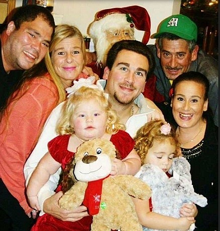 The DeLarso family in a Christmas photo. Samuel DeLarso is wearing the green baseball cap.