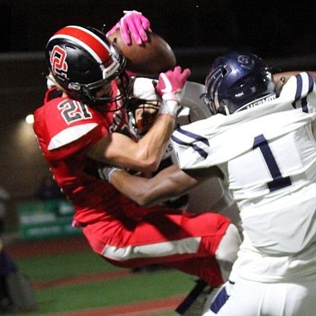 Ocean City wide receiver Brandon Lashley hauls in a touchdown pass despite tight coverage from St. Augustine.