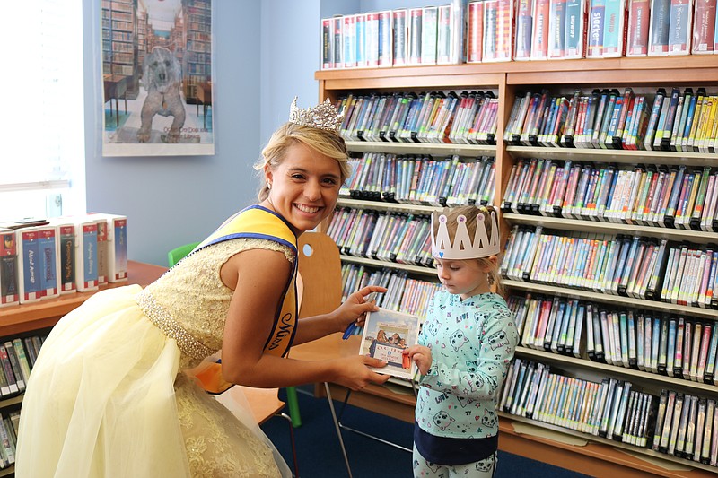 Miss Ocean City Megan Keenan picks out a book with Finley Corcory, 4, of Marmora.