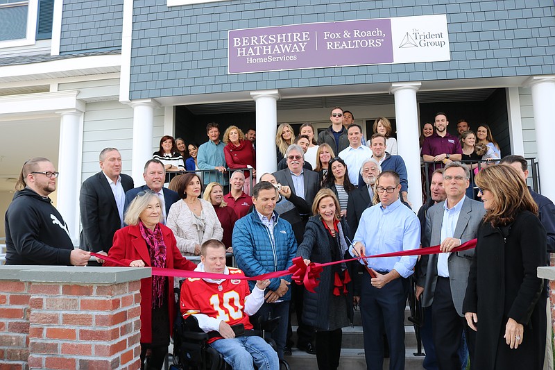 Berkshire Hathaway HomeServices Broker Manager Peter Madden cuts the ribbon during the Chamber of Commerce ceremony for the ribbon cutting. Executive Director of the Chamber Michele Gillian (right) says how the expansion is vital to the community because it shows growth and confidence Ocean City.