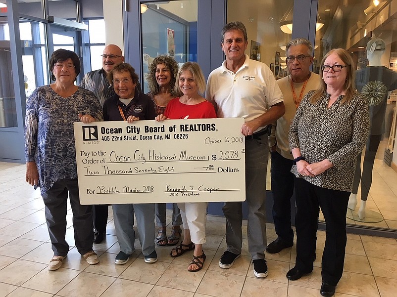 From left, Barbara Stefano, Museum vice president; Joseph Orazi, Long and Foster; Noel Wirth, Betsy King and Carol Dotts, Museum volunteers; Kenneth Cooper, Monihan Realty; and Al Crescenzo and Cathy Sauerzopf, Ocean City Board of Realtors. (Courtesy Ocean City Board of Realtors)